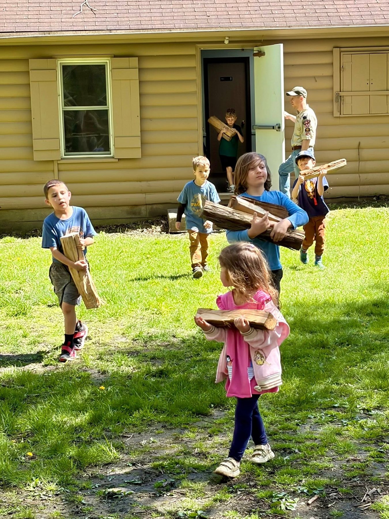 Pack 154 children carrying firewood at camp