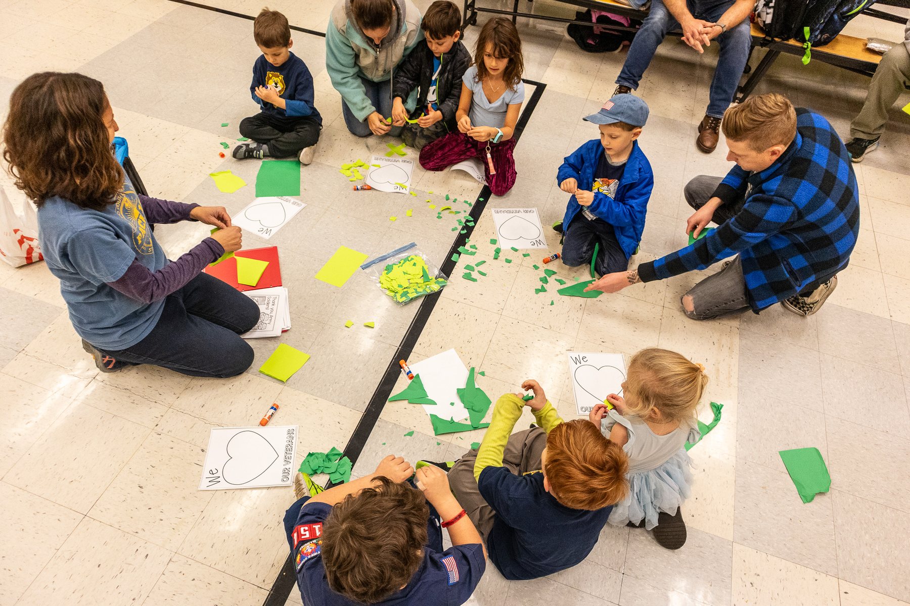 Children and adults making a craft together at a Pack 154 meeting
