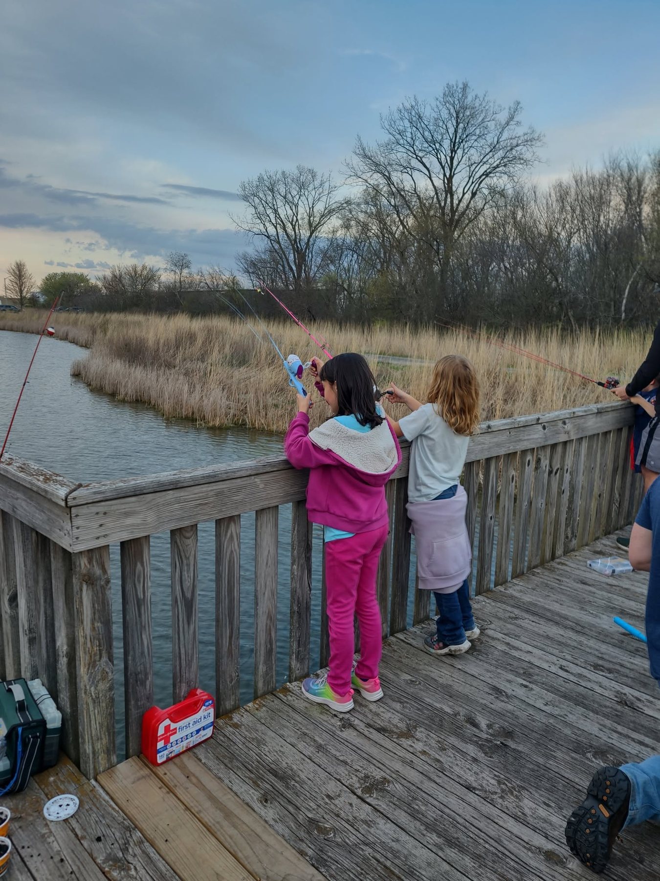 Children fishing together during a Pack 154 outing