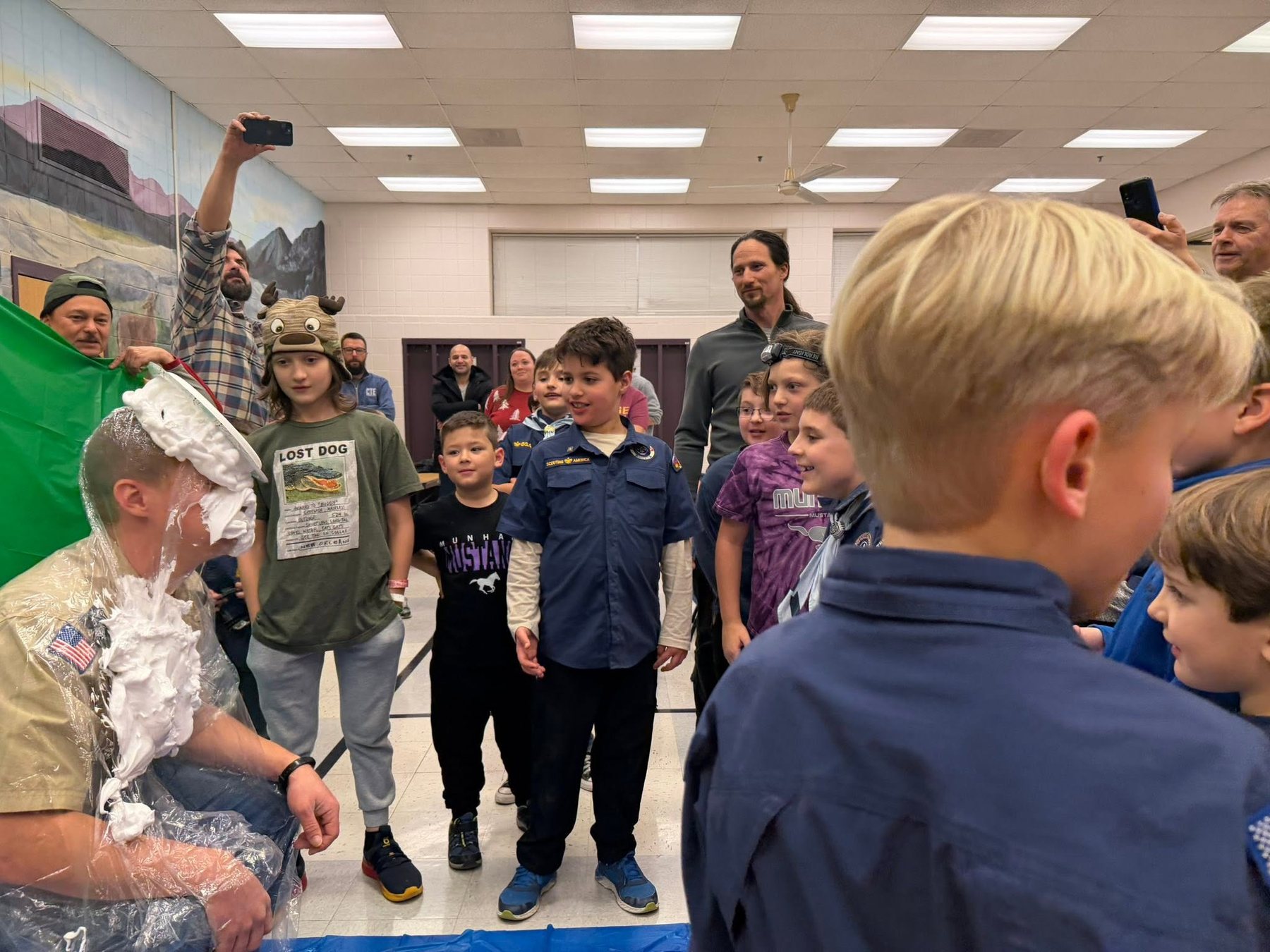 Pack 154 Scouts laughing together during a playful pack activity