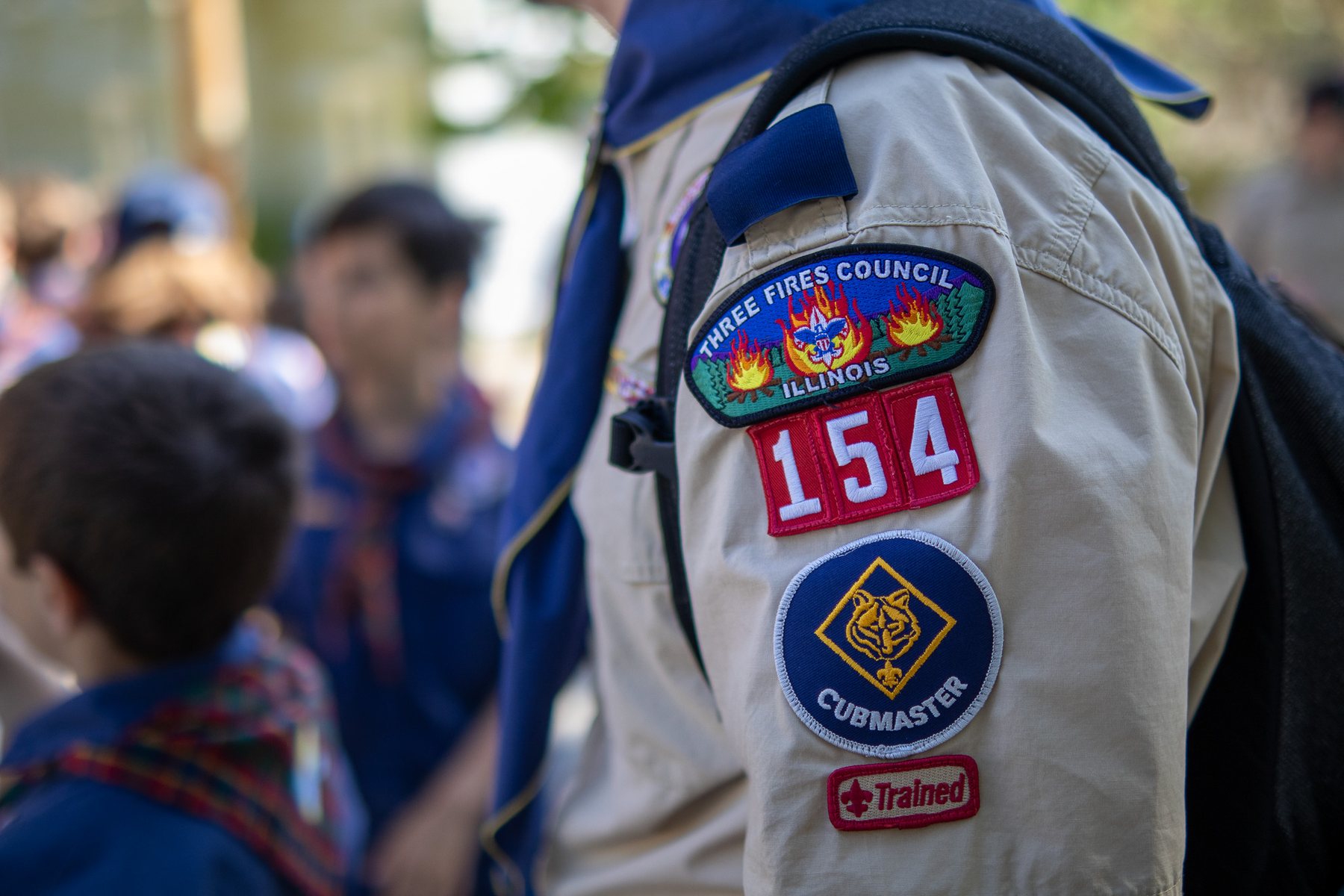 Pack 154 and Three Fires Council patches on a Cubmaster uniform